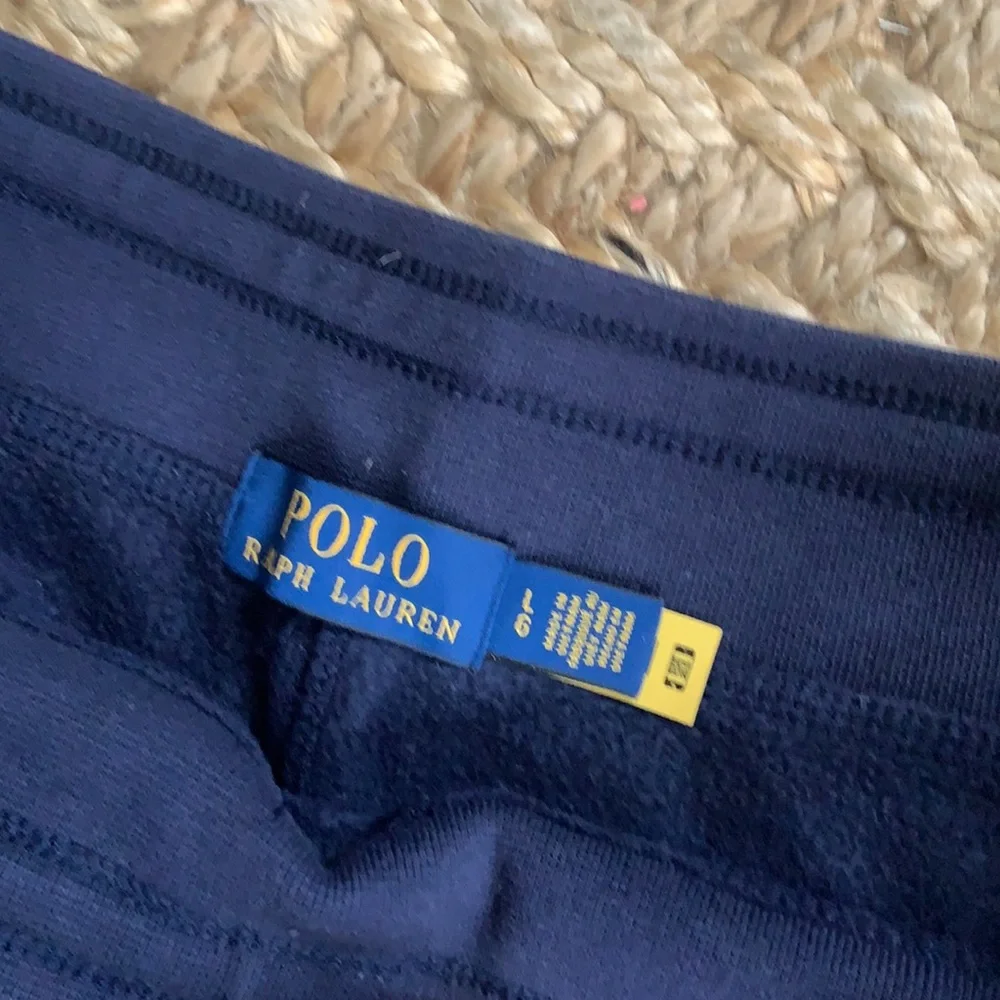 Polo navy sweatpants, two pockets, one in back, toes on the ankles.